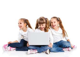 Three attractive girl using a laptop