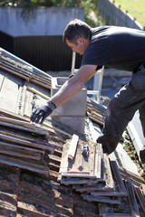 Roofer repairing a badly damaged roof