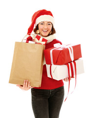Smiling girl in santa hat with bag full of xmas gift