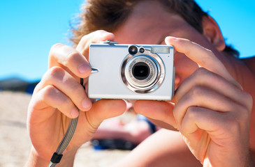 Digital compact photocamera in hands
