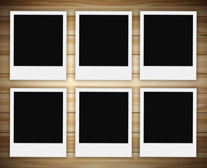 row of polaroid photo on wood background