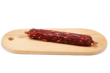 Sausage on a wooden cutting board isolated on white background.