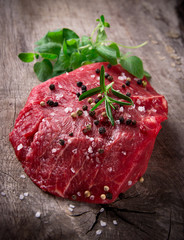Raw beef steak on wooden table