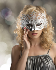 blonde girl with silver mask on the face