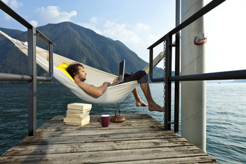 portrait of young man on hammock of Lake