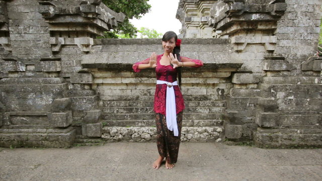 Balinese Girl Dancing Traditional Dance In Uluwatu Temple, Bali