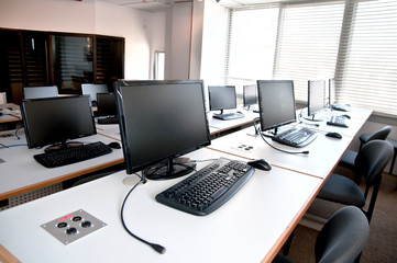 Obraz na płótnie Canvas Row of desktop PCs workplaces in the classroom