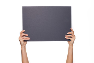 Woman's arms holding chalkboard