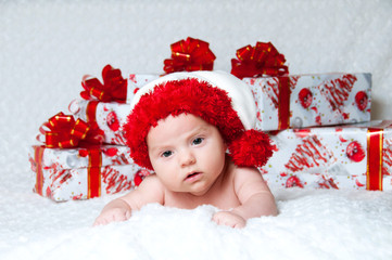 Newborn baby boy Santa Claus with Christmas gifts