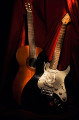 Two guitars: acoustic and electric in the darkness