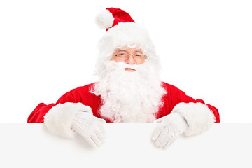 Santa Claus posing behind a blank billboard