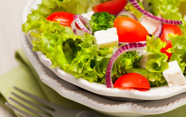 salad with tomatoes, broccoli, red onion and feta cheese