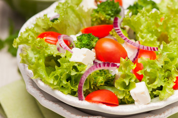 salad with tomatoes, broccoli, red onion and feta cheese