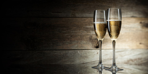 two glass with champagne on a wooden background