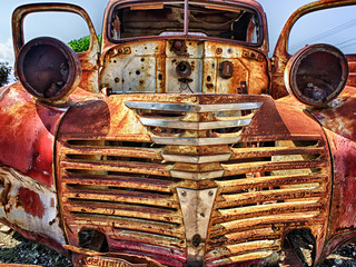 Abandoned rusty Oldtimer on a junk yard