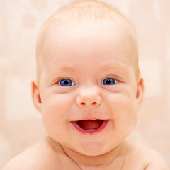 Beautiful smiling baby with bright blue eyes