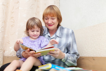 grandmother and baby reading book
