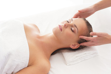 Fototapeta na wymiar A young woman relaxing on a spa massage procedure