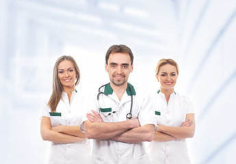 Fototapeta premium A team of young medical workers standing in white clothes