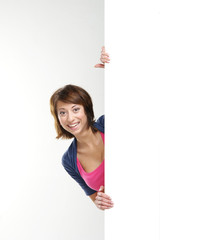 A happy teenage girl holding a large blank white banner