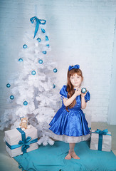 little girl under the Christmas tree