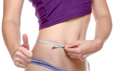Woman measuring her waist