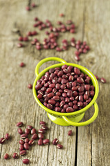Raw red beans in a green colander