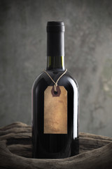 Red wine bottle with old paper label