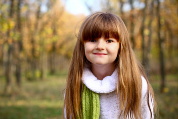 Portrait of a little girl in the autumn forest