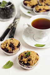 Black currant muffins with a cup of tea