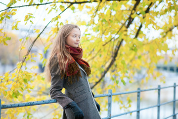 Young blond girl enjoying beautiful fall or spring day