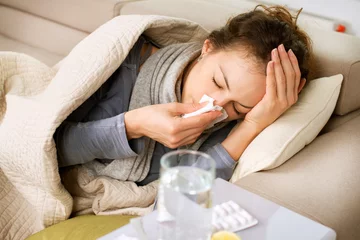 Fotobehang Sick Woman. Flu. Woman Caught Cold. Sneezing into Tissue © Subbotina Anna