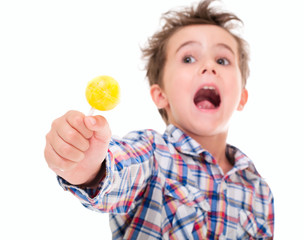 Little screaming excited boy with lollypop in hand