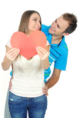 Couple in love smiling holding a red heart