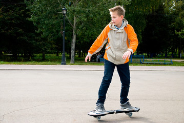 Teenager at the beginning of doing acrobatic stunt on waveboard