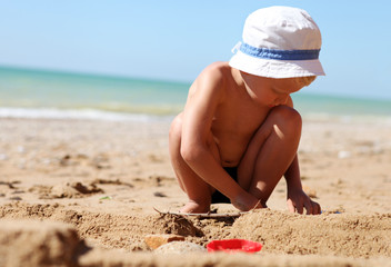 Little boy building sandcastle