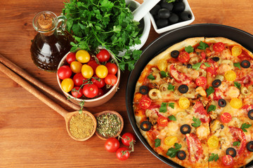 colorful composition of delicious pizza, vegetables and spices