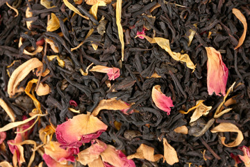 aromatic black dry tea with fruits and petals, close up