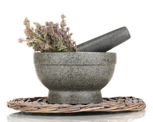 Thyme herb and mortar on wicker mat isolated on white
