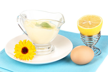 Mayonnaise in bowl on napkin isolated on white