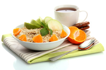 tasty oatmeal with orange and apple, cup of tea, isolated
