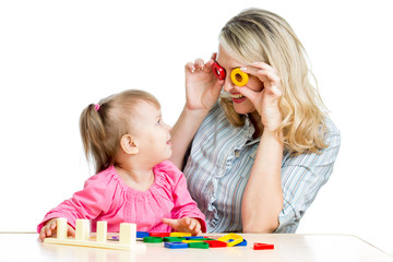 mother and her child fun games with colorful toy