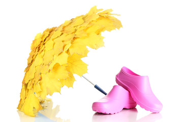 maple leaves umbrella with pink gumboots isolated on white