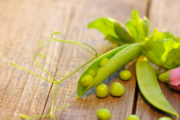 Fresh peas pods on a wooden table