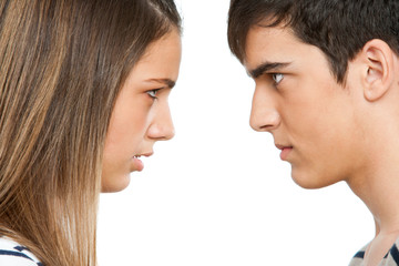 Teen couple with cross face expression.