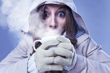 Young woman drinking hot coffee in winter © bonninturina