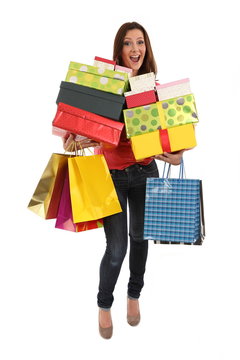 Happy woman with shopping bags and gifts