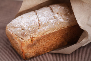 Bread loaf made of corn flour, rustic wrapped in paper bag