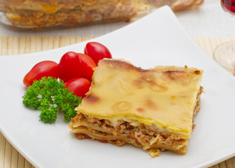 Lasagna with tomatoes, cheese and parsley