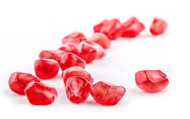 Pomegranate fruit seeds on white background